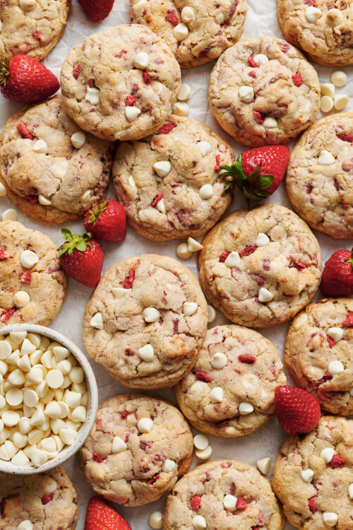 Strawberries and Cream Cookies bake up golden brown and are loaded with freeze dried strawberries (they pack in a ton of strawberry flavor) and white chocolate chips! Pretty, pink, and sure to please, these cookies will quickly become a family favorite. No cookie dough chilling required!